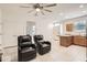 Open-concept living area featuring tile flooring, neutral walls, and natural light at 7665 W Fetlock Trl, Peoria, AZ 85383