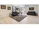 Spacious living room with neutral tile flooring, ceiling fan, and sliding glass doors at 7665 W Fetlock Trl, Peoria, AZ 85383