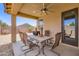 Covered outdoor patio perfect for dining and entertaining with outdoor fan at 7665 W Fetlock Trl, Peoria, AZ 85383