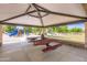 Community picnic area with shaded seating and playground in the background at 7665 W Fetlock Trl, Peoria, AZ 85383