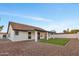 Backyard view showcasing a patio, green lawn, and white fence at 7685 W San Miguel Ave, Glendale, AZ 85303