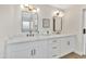 Bathroom with double sink vanity, quartz countertop, gold hardware, and modern lighting at 7685 W San Miguel Ave, Glendale, AZ 85303