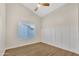 Bright bedroom with a ceiling fan, hardwood floors, natural light, and stylish trim at 7685 W San Miguel Ave, Glendale, AZ 85303