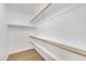 Walk-in closet with wooden racks and shelving at 7685 W San Miguel Ave, Glendale, AZ 85303