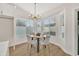 Dining area with modern chandelier, natural light, and access to the backyard area at 7685 W San Miguel Ave, Glendale, AZ 85303