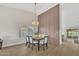 Bright dining room with vaulted ceilings, wood-look floors, and modern light fixture at 7685 W San Miguel Ave, Glendale, AZ 85303
