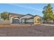 Charming single-story home featuring a two-car garage and desert landscaping in front at 7685 W San Miguel Ave, Glendale, AZ 85303