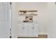 Hallway with white cabinets, quartz countertop, floating shelves, and modern design at 7685 W San Miguel Ave, Glendale, AZ 85303