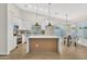 Modern kitchen with white cabinets, island, and stainless steel appliances at 7685 W San Miguel Ave, Glendale, AZ 85303