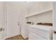 Laundry room with appliances, a door, and a shelf for storage at 7685 W San Miguel Ave, Glendale, AZ 85303