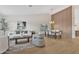 Bright living room with vaulted ceilings, wood-look floors, and elegant furniture at 7685 W San Miguel Ave, Glendale, AZ 85303