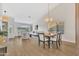 Open concept living and dining area with vaulted ceilings and wood-look floors at 7685 W San Miguel Ave, Glendale, AZ 85303