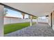 Covered patio with a stone floor and views of the backyard lawn at 7685 W San Miguel Ave, Glendale, AZ 85303