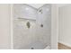 Walk-in shower features white tiling and a built-in niche for storage at 7685 W San Miguel Ave, Glendale, AZ 85303