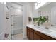 Bright bathroom features a double sink vanity with a white countertop and wood cabinets, plus a bathtub shower combo at 8027 W Northview Ave, Glendale, AZ 85303