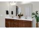 This bathroom is bright and airy with a double sink vanity, a large mirror, and modern fixtures and decor at 8027 W Northview Ave, Glendale, AZ 85303