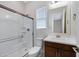 This well-lit bathroom offers a glass door shower and modern vanity with a single sink and neutral wall color at 8027 W Northview Ave, Glendale, AZ 85303