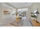 Open-concept dining area with views of the living room and modern decor at 8027 W Northview Ave, Glendale, AZ 85303