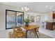 Stylish dining room with modern lighting and easy access to the kitchen and backyard at 8027 W Northview Ave, Glendale, AZ 85303