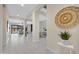 Open hallway featuring views of the living room, dining area and contemporary decor at 8027 W Northview Ave, Glendale, AZ 85303