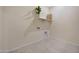 A tiled utility room offering laundry hookups and overhead shelving with modern plant accent decor at 8027 W Northview Ave, Glendale, AZ 85303