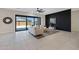 Comfortable living room with a large sliding glass door and a stylish accent wall at 8027 W Northview Ave, Glendale, AZ 85303