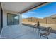 Covered patio with table and chairs overlooking the backyard and block wall fence at 8027 W Northview Ave, Glendale, AZ 85303