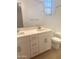 Bright bathroom with double vanity, white cabinets, and tiled floors for a clean design at 805 W Lark Dr # 243, Queen Creek, AZ 85140