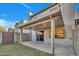 Covered back patio and block wall for privacy, with artificial grass and sliding door at 8619 N 67Th Dr, Peoria, AZ 85345