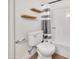 Bathroom features wood shelves, tile floor, toilet, and tiled shower and shower curtain at 8619 N 67Th Dr, Peoria, AZ 85345