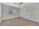 Bright bedroom with a ceiling fan, carpet, and modern wainscoting at 8619 N 67Th Dr, Peoria, AZ 85345
