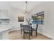 Cozy dining room with modern chandelier, wood floors, and a large window offering ample natural light at 8619 N 67Th Dr, Peoria, AZ 85345