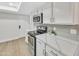 Modern kitchen featuring white cabinets, stainless steel appliances, and light gray subway tile backsplash at 8619 N 67Th Dr, Peoria, AZ 85345