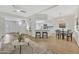 Open-concept kitchen boasts white cabinets, modern appliances, breakfast bar and adjacent dining area at 8619 N 67Th Dr, Peoria, AZ 85345