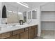 The bathroom features a double sink vanity with wooden cabinets and large mirrors at 8753 E Plata Ave, Mesa, AZ 85212