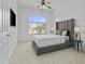 This bedroom features a large window, carpeted floor, and ceiling fan at 8753 E Plata Ave, Mesa, AZ 85212