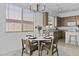 Cozy dining area with modern chandelier and view into the kitchen at 8753 E Plata Ave, Mesa, AZ 85212