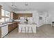 The kitchen is equipped with wooden cabinets, white appliances, and a central island with seating at 8753 E Plata Ave, Mesa, AZ 85212