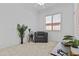 This living room area showcases a comfortable chair and a view of the front door at 8753 E Plata Ave, Mesa, AZ 85212