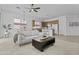 Bright living space features plush carpeting, a ceiling fan, and lots of natural light at 8753 E Plata Ave, Mesa, AZ 85212