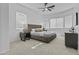 Bright main bedroom features neutral color scheme, ceiling fan, and two side tables at 8753 E Plata Ave, Mesa, AZ 85212