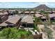 Bird's-eye view of home featuring a backyard with artificial grass, covered patio, fire pit, and golf cart at 8820 E Ivy Cir, Mesa, AZ 85207