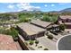 Aerial view of a property showcasing its desert landscaping, tile roof, and proximity to the community at 8820 E Ivy Cir, Mesa, AZ 85207