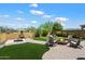 Landscaped backyard with a firepit and lounge chairs at 8820 E Ivy Cir, Mesa, AZ 85207