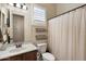 Bathroom has a single vanity with wood cabinet and a shower and tub combo at 8820 E Ivy Cir, Mesa, AZ 85207