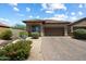 Charming single-story home with a well-manicured front yard and brick paved driveway at 8820 E Ivy Cir, Mesa, AZ 85207