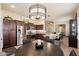 This expansive kitchen has stainless appliances, granite counters and lots of dark wood cabinetry at 8820 E Ivy Cir, Mesa, AZ 85207