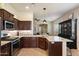 Open kitchen featuring granite countertops, stainless steel appliances, and easy access to the living room at 8820 E Ivy Cir, Mesa, AZ 85207