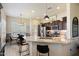 Modern kitchen with granite countertops, stainless steel appliances, and a breakfast bar at 8820 E Ivy Cir, Mesa, AZ 85207