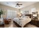 Comfortable main bedroom features plantation shutters, neutral walls, and decorative touches at 8820 E Ivy Cir, Mesa, AZ 85207